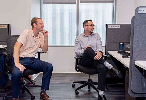 Two employees looking at computer