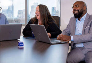 Two CSG consultants smiling in meeting